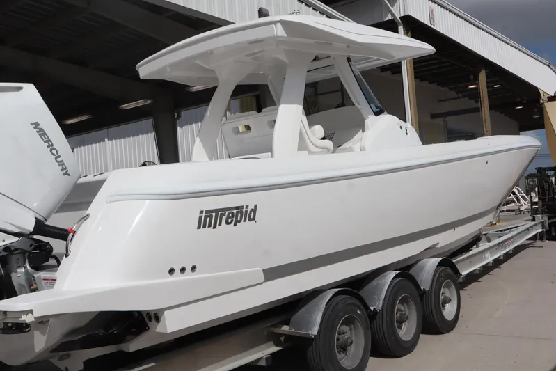  Yacht Photos Pics 2026 Intrepid 375 Nomad SE boat on trailer, featuring sleek white design.