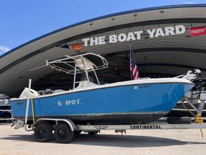 1998 Mako 221 CC boat on trailer at The Boat Yard, blue hull, American flag displayed.