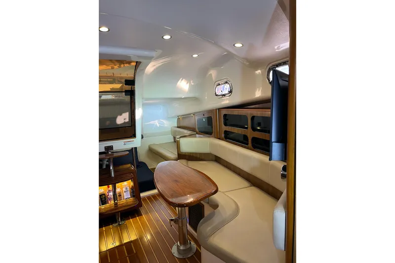  Yacht Photos Pics Luxurious interior of 2009 Pursuit OS 375 Offshore boat with elegant seating and wooden accents.
