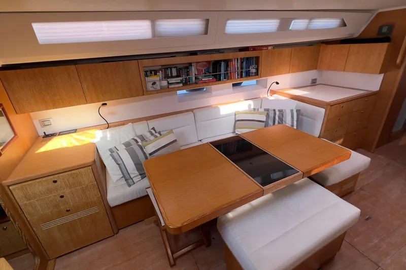  Yacht Photos Pics Luxurious interior of 2012 Grand Soleil 50 yacht with cozy seating and wooden cabinetry.