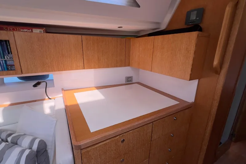  Yacht Photos Pics Interior of 2012 Grand Soleil 50 yacht with wooden cabinetry and cozy sleeping area.
