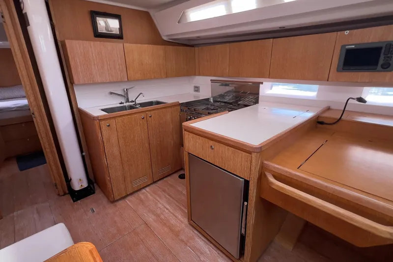  Yacht Photos Pics Interior of 2012 Grand Soleil 50 yacht featuring a modern kitchen with wood cabinetry.