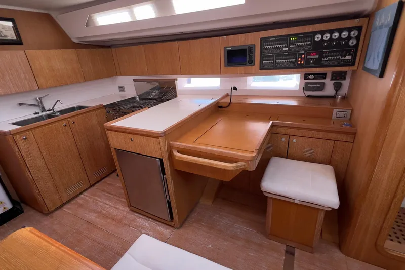  Yacht Photos Pics Interior of 2012 Grand Soleil 50 yacht with wooden cabinetry and navigation station.
