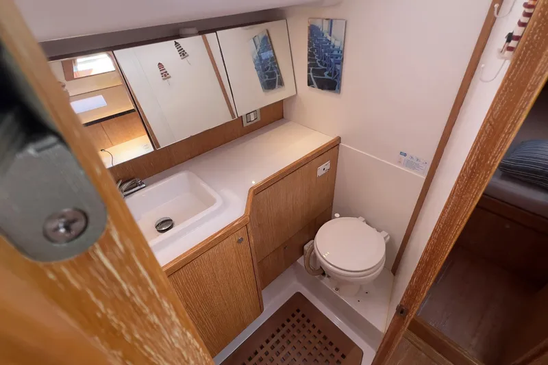  Yacht Photos Pics Bathroom interior of 2012 Grand Soleil 50 yacht with sink, toilet, and wooden cabinetry.