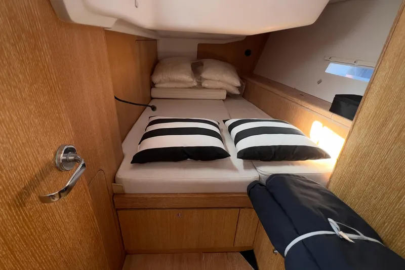  Yacht Photos Pics Cozy cabin interior of 2012 Grand Soleil 50 yacht with striped pillows.
