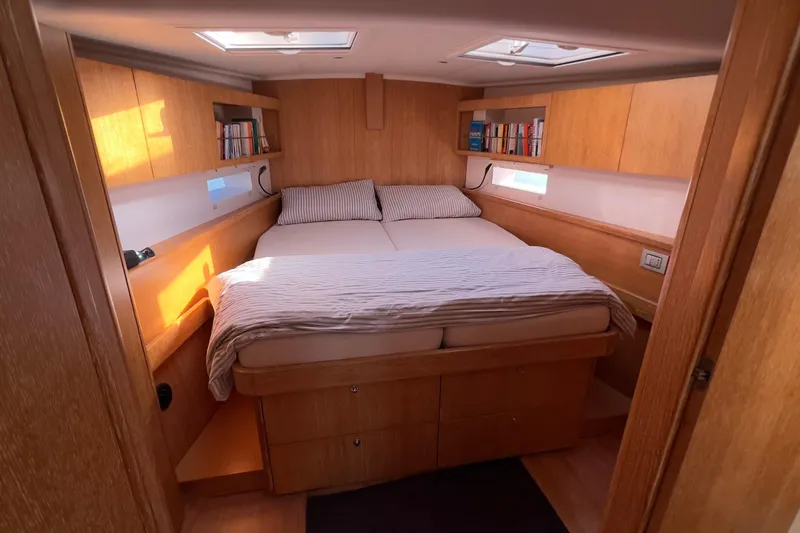  Yacht Photos Pics Luxurious cabin interior of 2012 Grand Soleil 50 yacht with cozy bed and wooden finish.