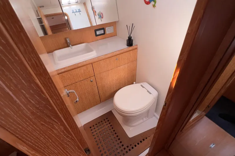  Yacht Photos Pics Luxurious bathroom in 2012 Grand Soleil 50 yacht with wooden cabinetry and modern fixtures.