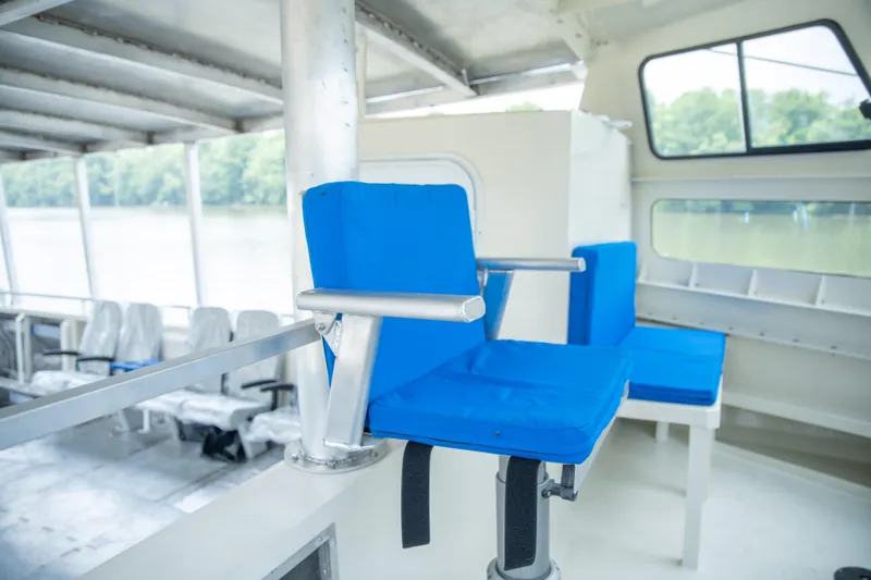 Penelope Yacht Photos Pics Interior of 2023 Smoky Mountain catamaran with blue seating and large windows.