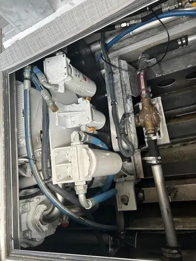 Penelope Yacht Photos Pics Engine compartment of 2023 Smoky Mountain asymmetrical foil-assisted catamaran, showing mechanical components and hoses.
