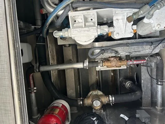 Penelope Yacht Photos Pics Engine compartment of 2023 Smoky Mountain asymmetrical foil-assisted catamaran, showing mechanical components and fire extinguisher.