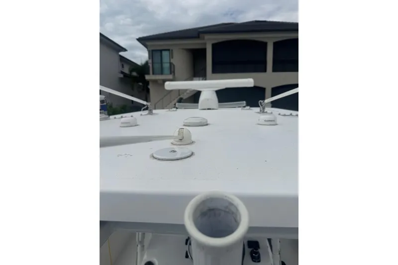  Yacht Photos Pics 2024 Invincible 39 Open Fisherman boat deck with equipment, residential background.