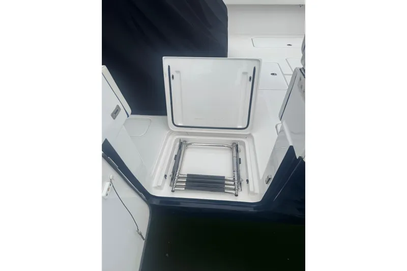  Yacht Photos Pics 2024 Invincible 39 Open Fisherman boat storage compartment with ladder.