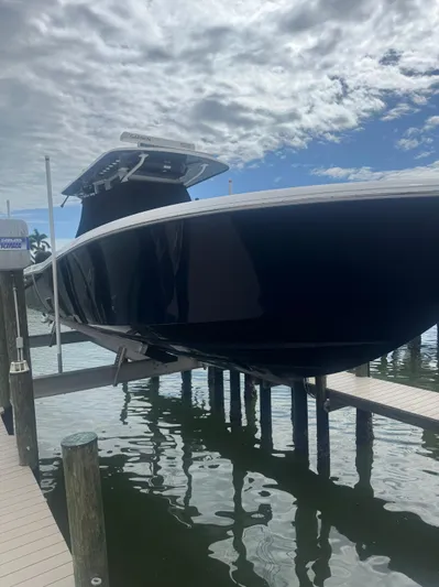  Yacht Photos Pics 2024 Invincible 39 Open Fisherman boat docked under cloudy sky.