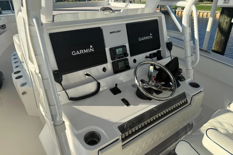  Yacht Photos Pics 2024 Invincible 39 Open Fisherman helm with Garmin displays and Mercury controls.