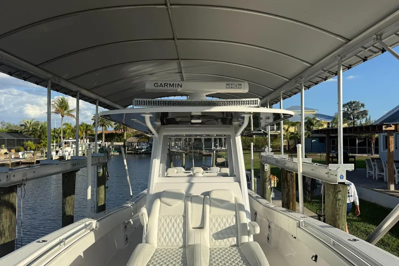  Yacht Photos Pics 2024 Invincible 39 Open Fisherman boat docked under canopy, featuring Garmin equipment.
