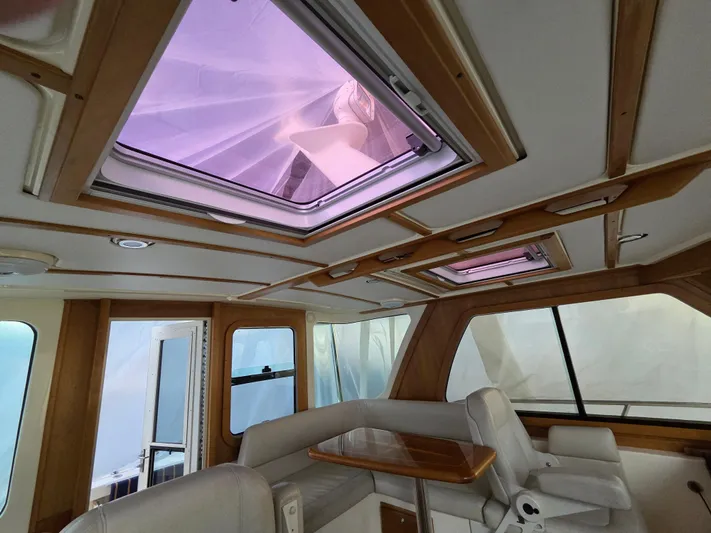 Escapade Yacht Photos Pics Interior of 2007 Sabre 34 Hardtop Express with skylights and seating area.