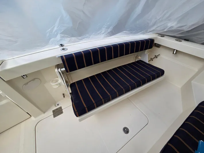 Escapade Yacht Photos Pics 2007 Sabre 34 Hardtop Express boat with striped seating in the cockpit area.