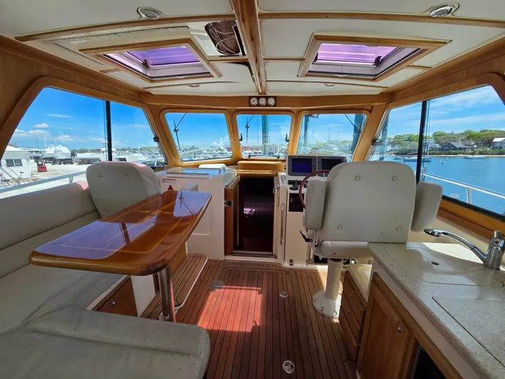 Escapade Yacht Photos Pics Interior of 2007 Sabre 34 Hardtop Express yacht with wood accents and panoramic windows.