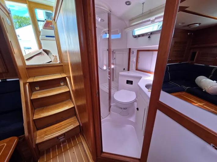 Escapade Yacht Photos Pics 2007 Sabre 34 Hardtop Express interior with wooden stairs, bathroom, and seating area.