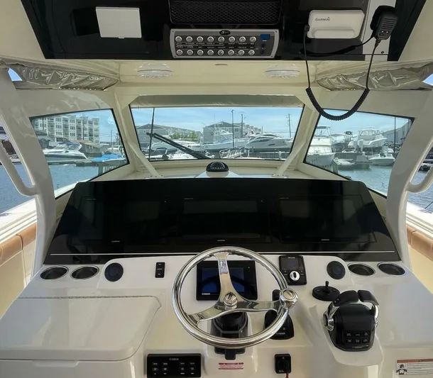 Shady Lady 2 Yacht Photos Pics Interior view of 2019 Scout 380LXF boat cockpit in harbor.