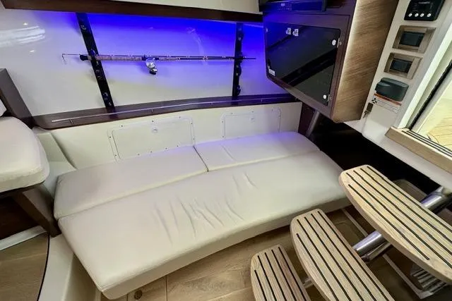  Yacht Photos Pics 2021 Boston Whaler 345 Conquest Pilothouse interior with seating, rod holder, and ambient lighting.