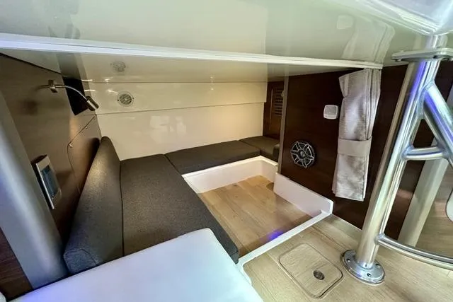  Yacht Photos Pics Interior cabin of 2021 Boston Whaler 345 Conquest Pilothouse, featuring modern seating and wood flooring.
