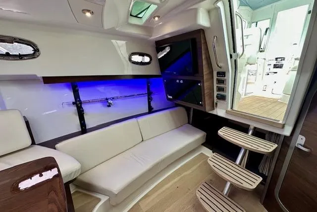  Yacht Photos Pics Interior of 2021 Boston Whaler 345 Conquest Pilothouse with modern seating and ambient lighting.