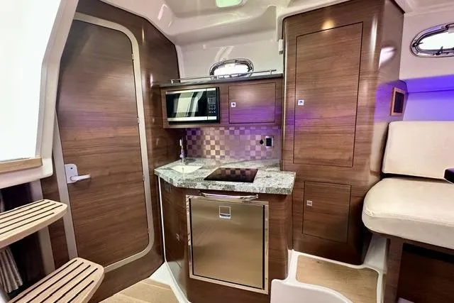  Yacht Photos Pics 2021 Boston Whaler 345 Conquest Pilothouse interior with modern kitchen amenities.