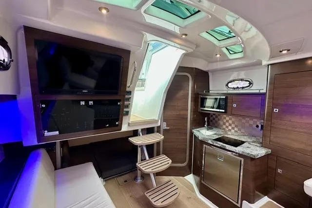  Yacht Photos Pics Interior of 2021 Boston Whaler 345 Conquest Pilothouse with modern kitchen and seating area.