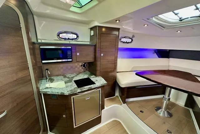  Yacht Photos Pics Luxurious interior of 2021 Boston Whaler 345 Conquest Pilothouse with modern kitchen and seating area.