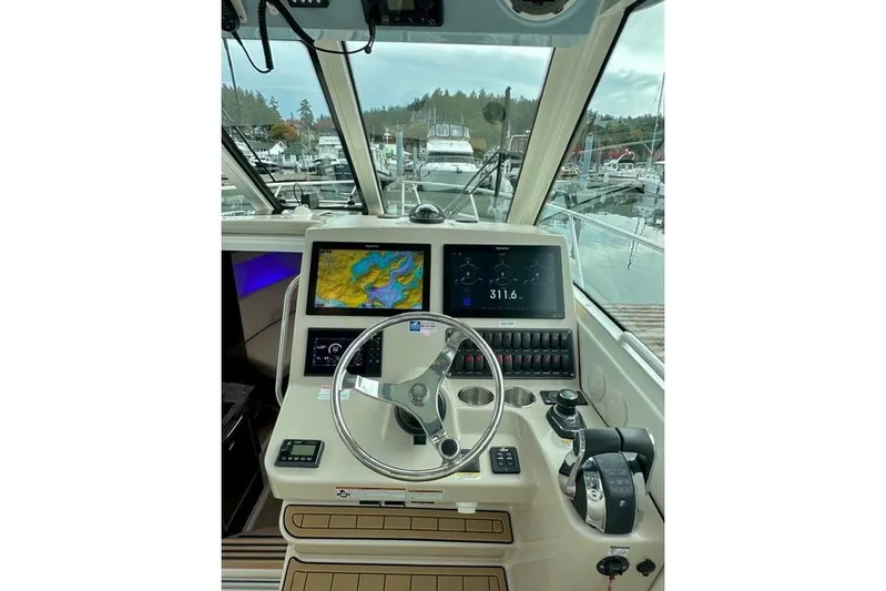  Yacht Photos Pics 2021 Boston Whaler 345 Conquest Pilothouse helm with navigation screens and controls.