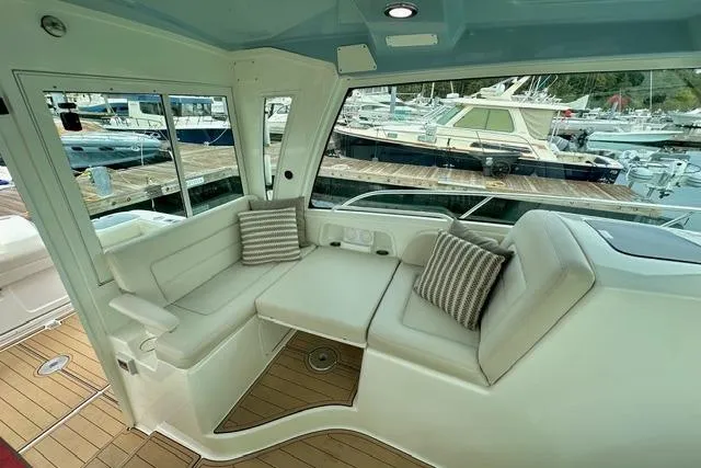  Yacht Photos Pics 2021 Boston Whaler 345 Conquest Pilothouse interior with cushioned seating and marina view.