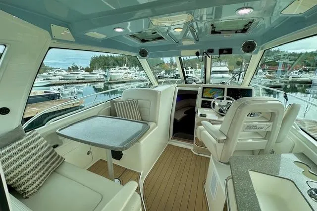  Yacht Photos Pics Interior of 2021 Boston Whaler 345 Conquest Pilothouse, featuring modern seating and navigation.