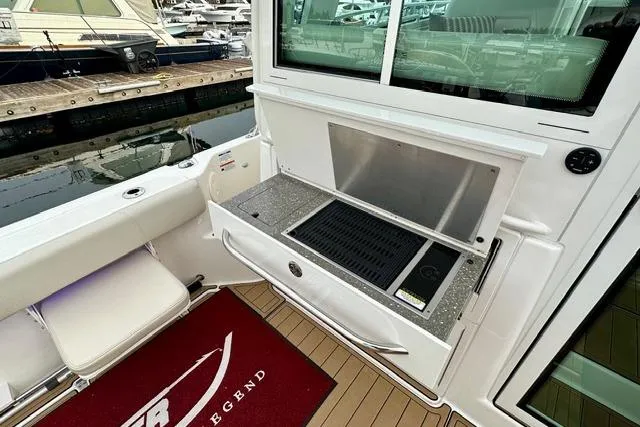  Yacht Photos Pics Boston Whaler 345 Conquest Pilothouse 2021 with outdoor grill and seating at marina.