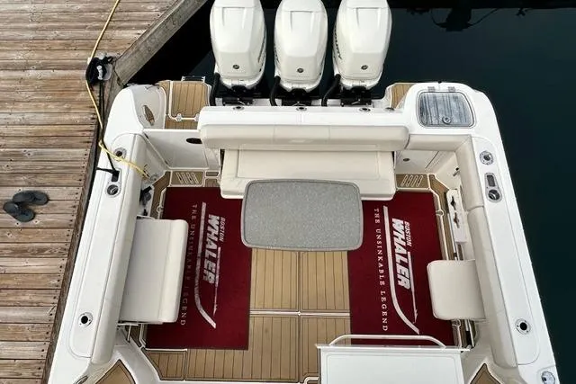  Yacht Photos Pics 2021 Boston Whaler 345 Conquest Pilothouse with triple engines, docked, featuring spacious deck area.