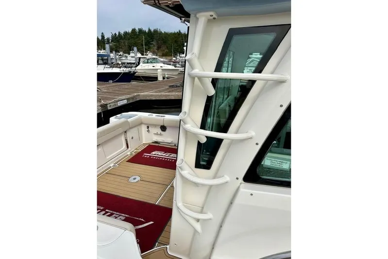  Yacht Photos Pics 2021 Boston Whaler 345 Conquest Pilothouse docked, showcasing sleek design and spacious deck.