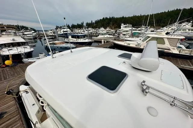  Yacht Photos Pics 2021 Boston Whaler 345 Conquest Pilothouse docked in a marina with multiple boats.