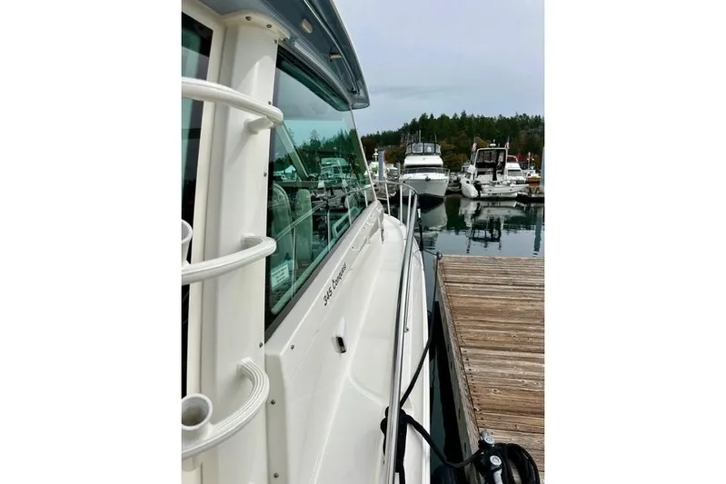 Yacht Photos Pics Boston Whaler 345 Conquest Pilothouse 2021 docked at marina, side view.