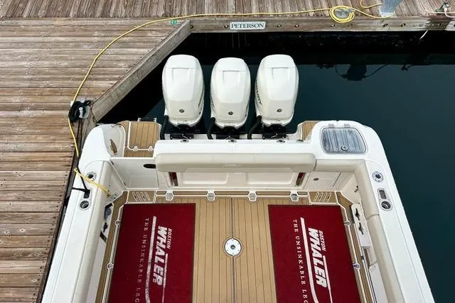  Yacht Photos Pics Boston Whaler 345 Conquest Pilothouse 2021 docked, featuring triple outboard engines.