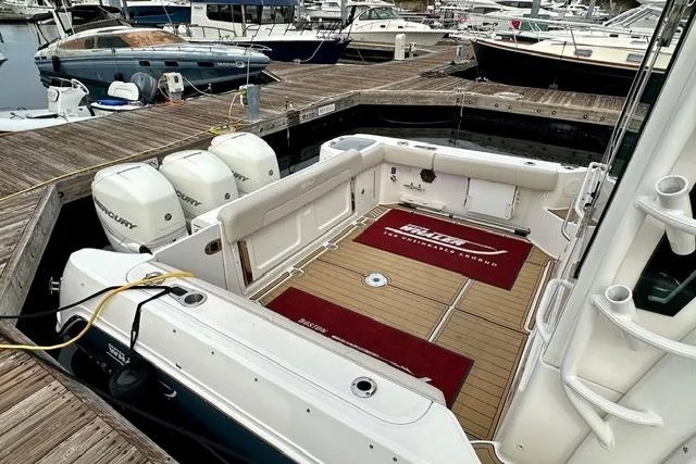  Yacht Photos Pics 2021 Boston Whaler 345 Conquest Pilothouse docked, showcasing spacious deck and triple outboard engines.
