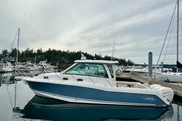  Yacht Photos Pics 2021 Boston Whaler 345 Conquest Pilothouse docked in a marina, side view.