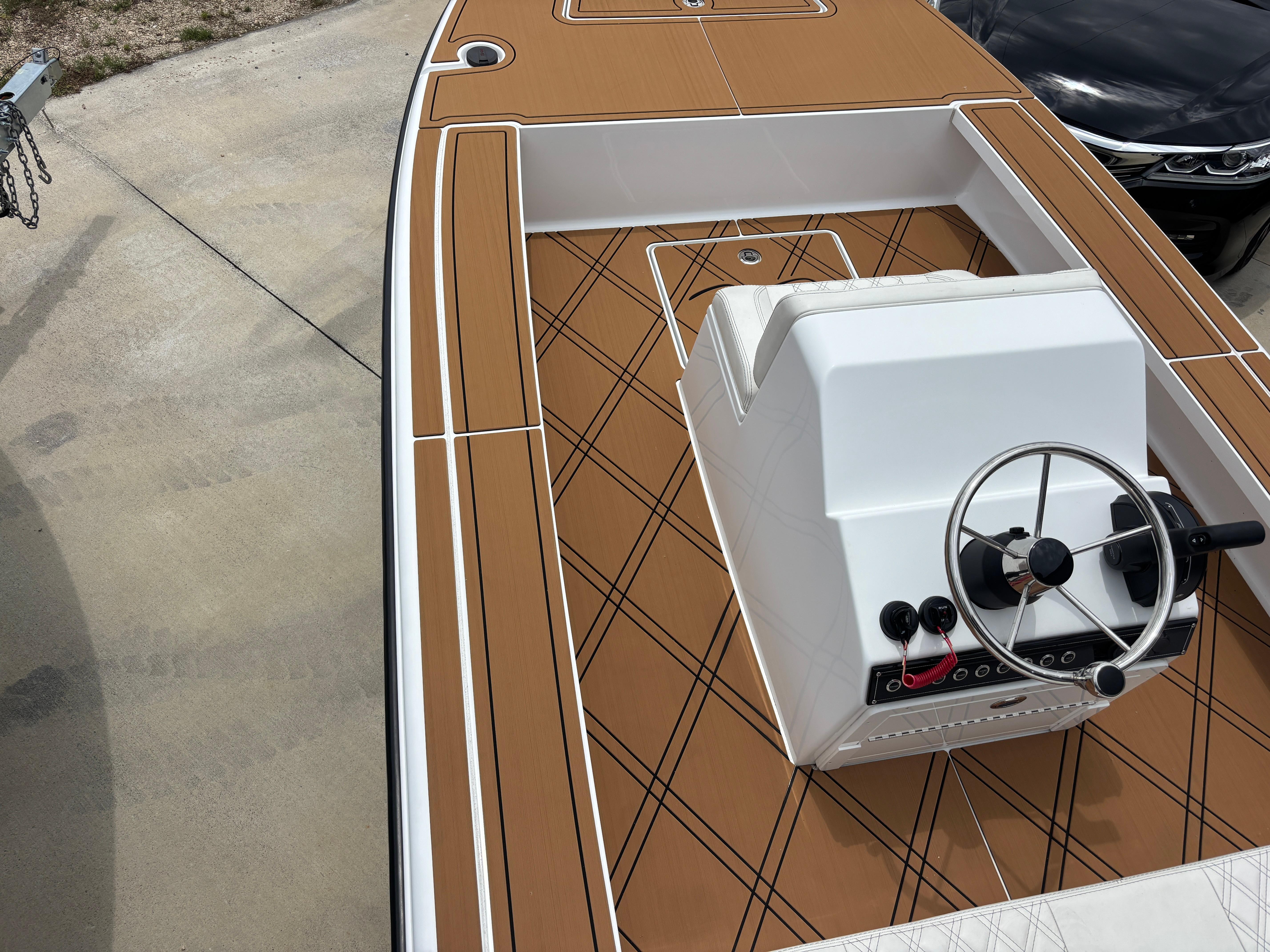 2024 Vtech 18 FLATS boat with brown deck and white console, featuring a steering wheel.