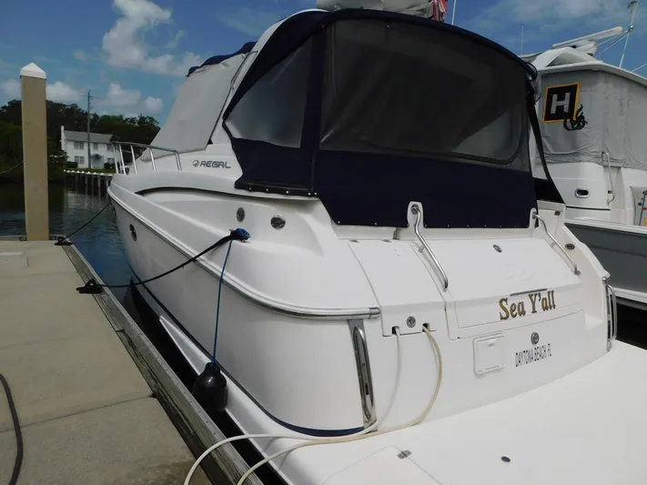 Sea Y'all Yacht Photos Pics 2004 Regal Commodore 3860 yacht docked, featuring a white exterior and blue canopy.