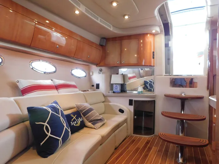 Sea Y'all Yacht Photos Pics Luxurious interior of 2004 Regal Commodore 3860 yacht with elegant seating and wooden accents.