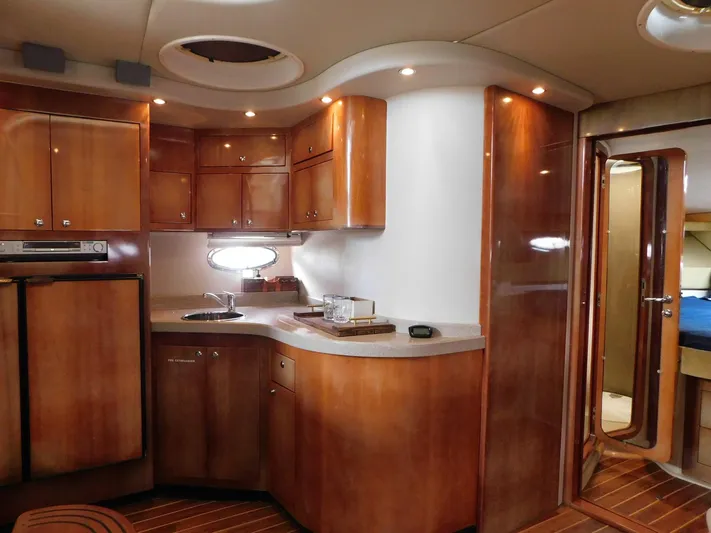Sea Y'all Yacht Photos Pics Luxurious 2004 Regal Commodore 3860 yacht interior with wood cabinetry and modern amenities.