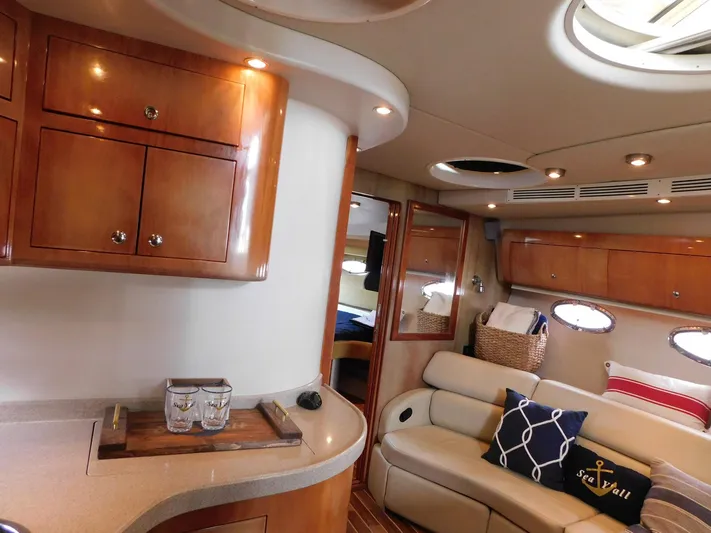 Sea Y'all Yacht Photos Pics Luxurious interior of 2004 Regal Commodore 3860 yacht with elegant wood cabinetry and plush seating.