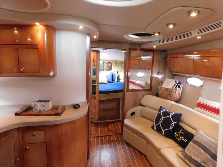Sea Y'all Yacht Photos Pics Luxurious interior of 2004 Regal Commodore 3860 yacht with elegant wood finishes and cozy seating.