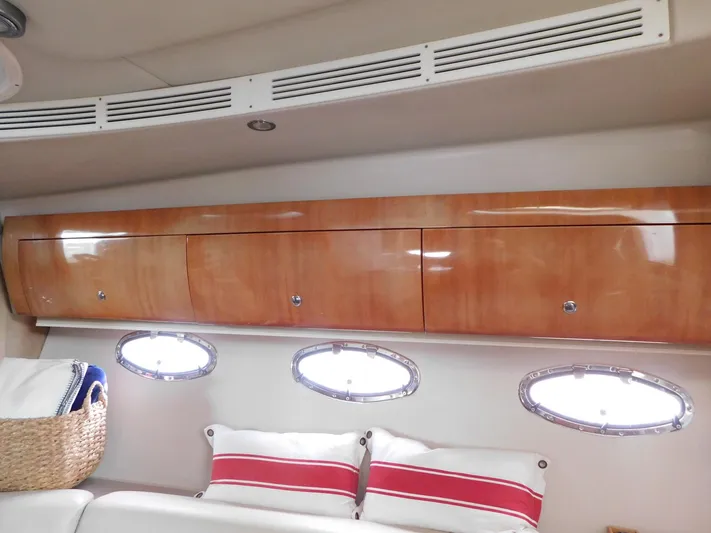 Sea Y'all Yacht Photos Pics Interior of 2004 Regal Commodore 3860 yacht with wooden cabinets and porthole windows.