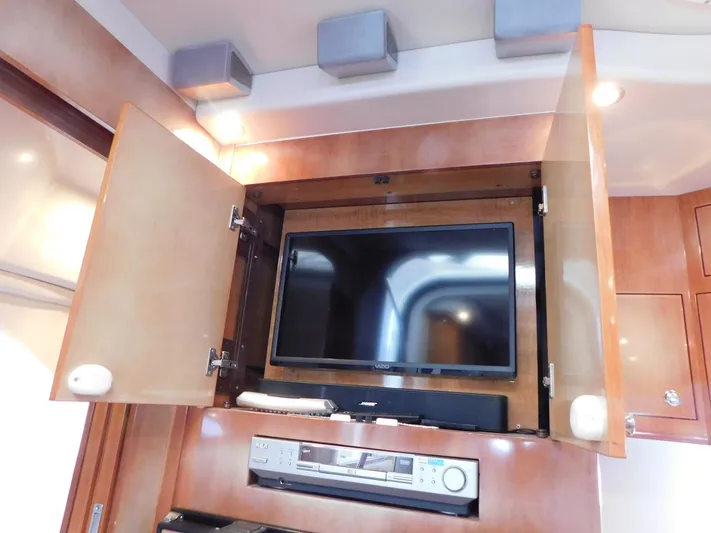 Sea Y'all Yacht Photos Pics 2004 Regal Commodore 3860 interior with TV and audio system in wooden cabinet.