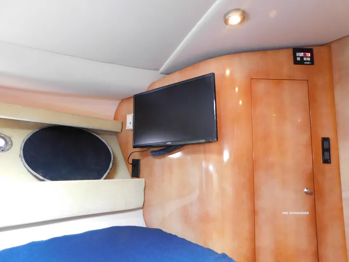 Sea Y'all Yacht Photos Pics Interior of 2004 Regal Commodore 3860 yacht with TV and wood paneling.